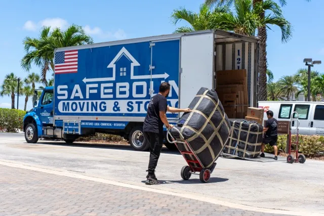 Safebound moving truck and crew loading furniture outside a customer home